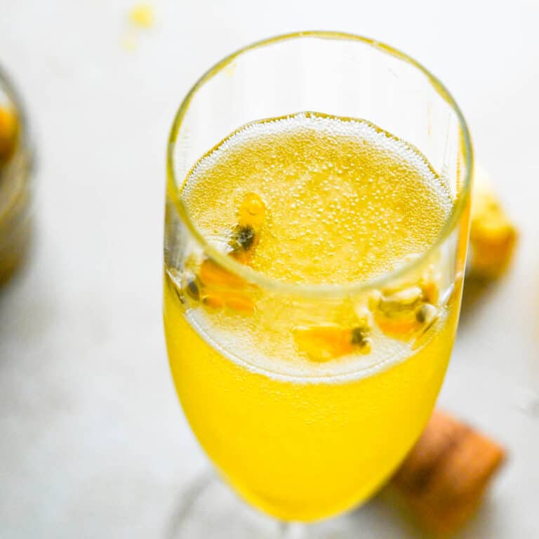 champagne and passion fruit cocktail in a flute glass.