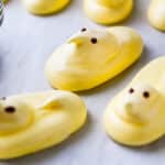 Lemon meringue peeps on a sheet pan.