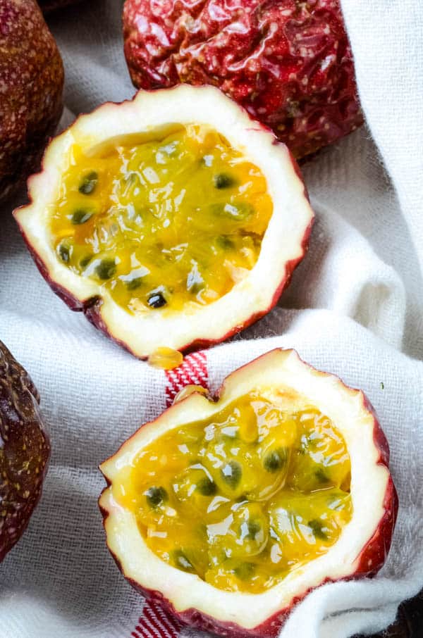 ripe passion fruit, sliced in half to show passion fruit pulp.