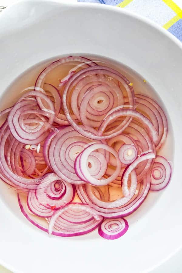 covering onions with brining liquid.