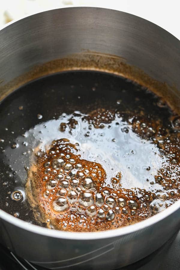 cooking the vinegar and caramel together.