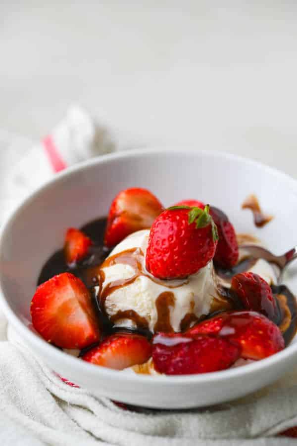 Balsamic caramel with a dish of ice cream and berries.