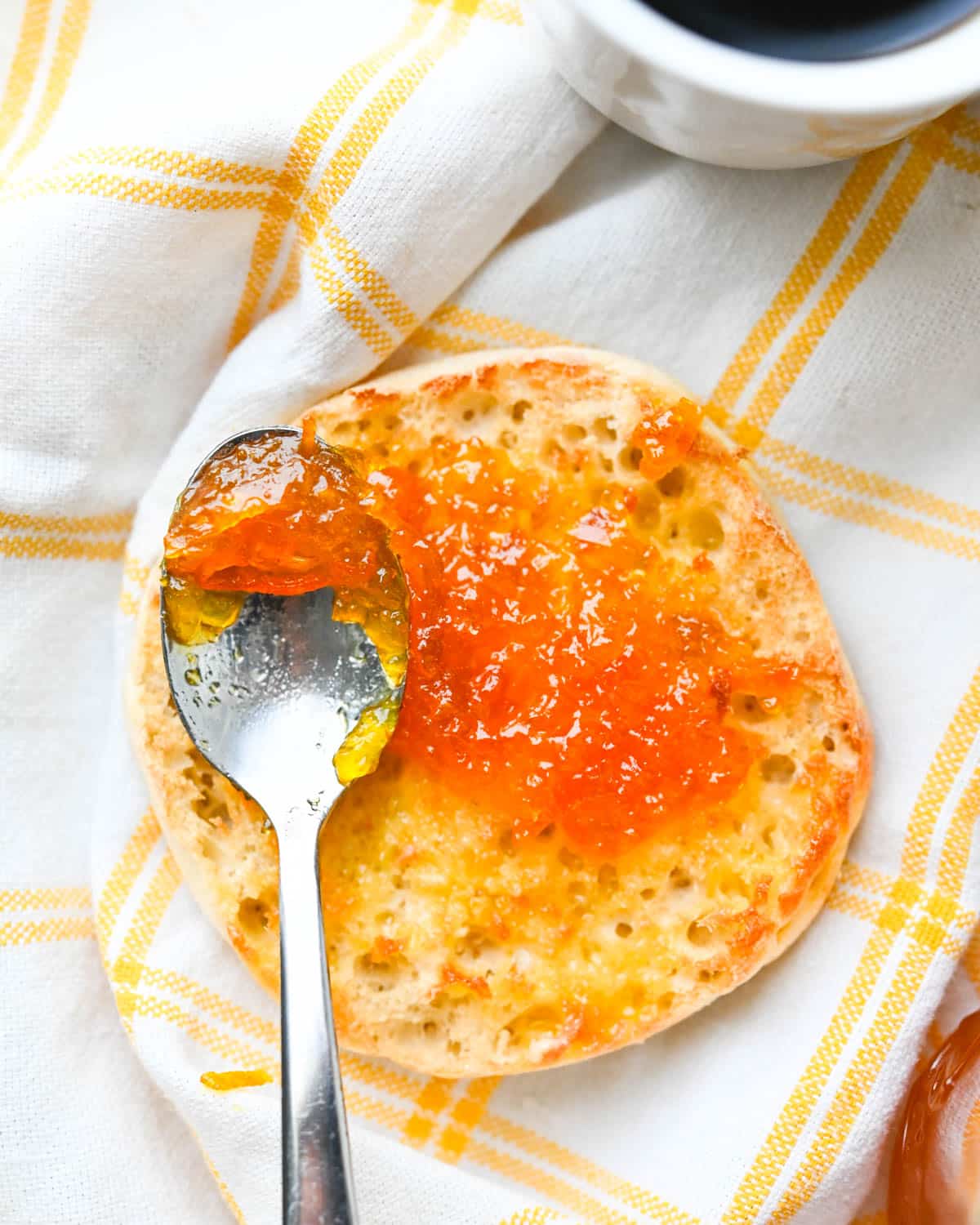 Spreading calamansi lime marmalade on an English Muffin.