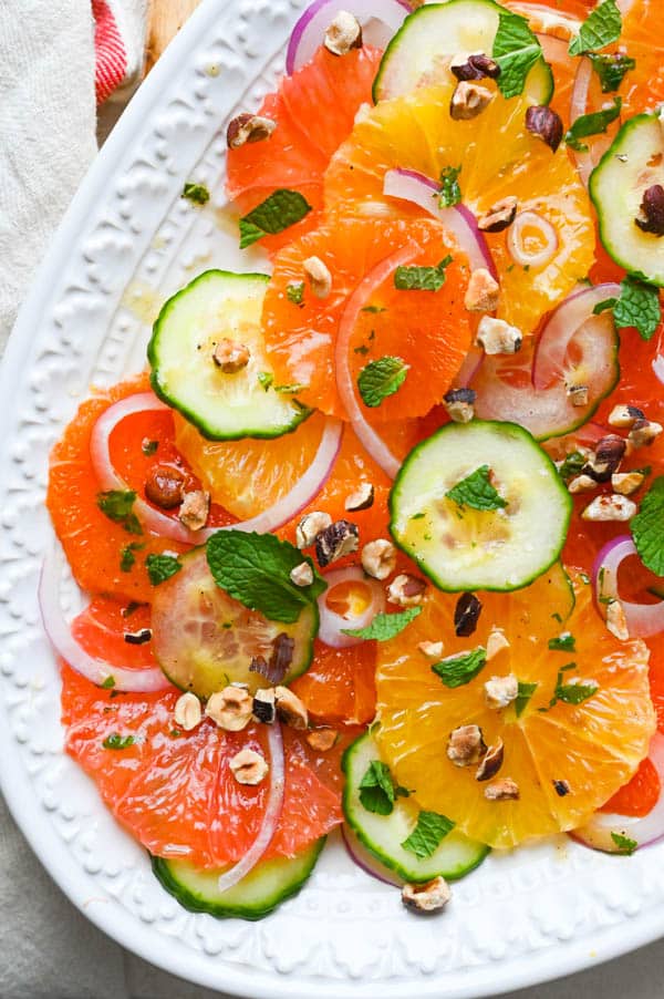 a platter of citrus salad with fresh mint and hazelnuts.
