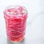 a jar of pink pickled onions.