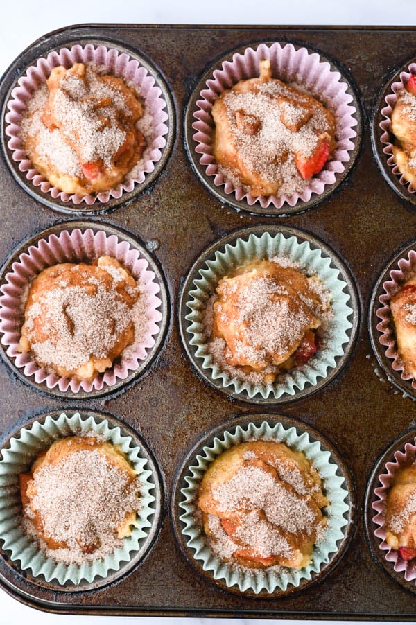 sprinkling strawberry muffins with cinnamon sugar.
