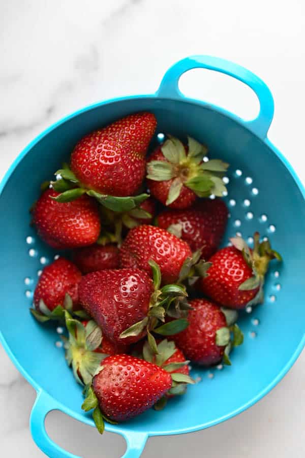 colander of fresh strawberries.