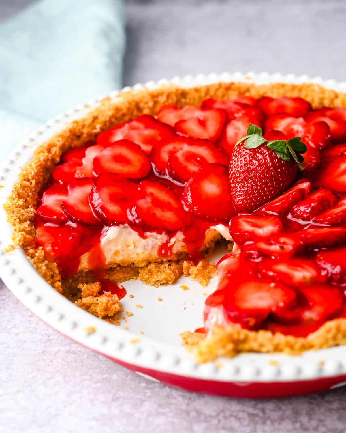 Strawberry ricotta pie with a slice missing.