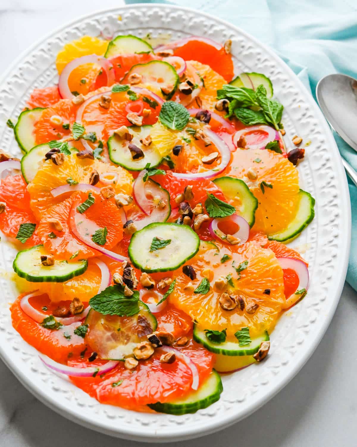 A platter of winter citrus salad with chopped hazelnuts.