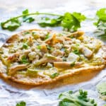 a crispy fried chalupa topped with simple shredded chicken, cotija cheese and cilantro.