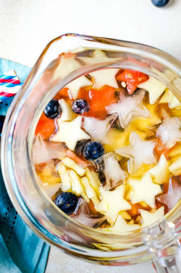 refreshing red white and blue sangria in a pitcher.