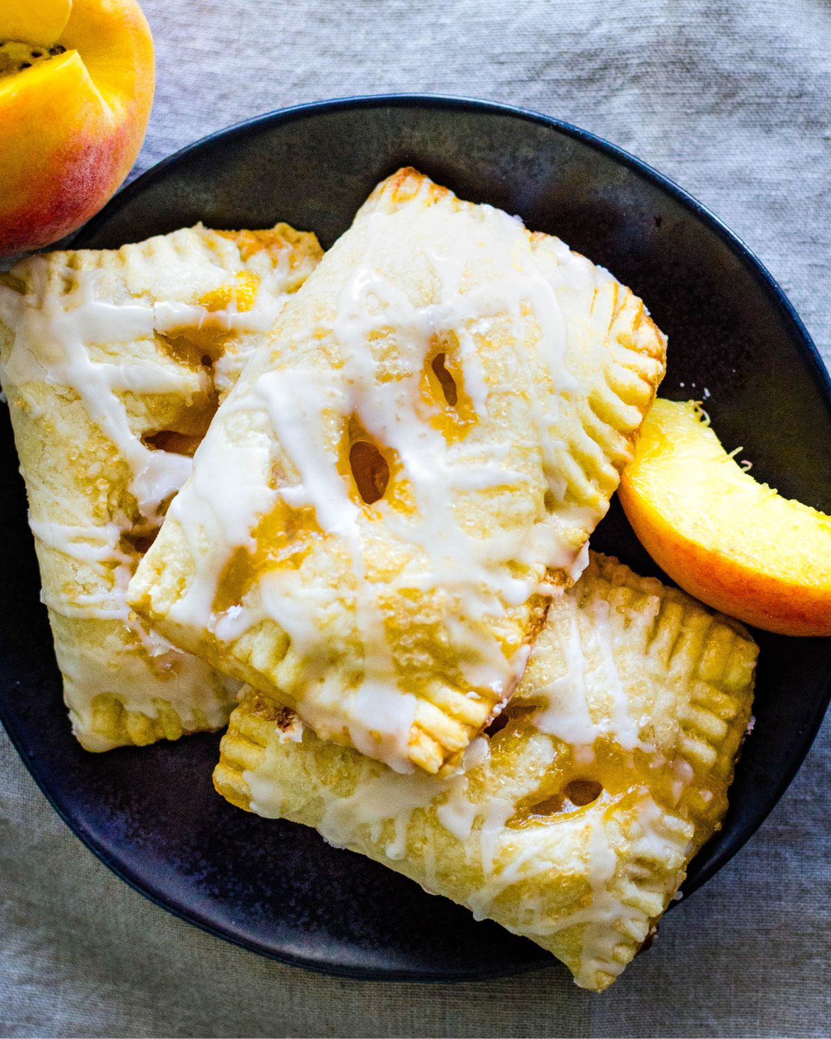 A plate filled with peach hand pies.