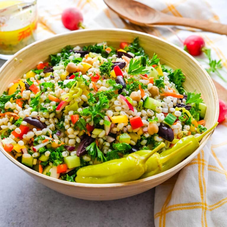 chopped barley salad with pepperoncini in a large serving bowl.