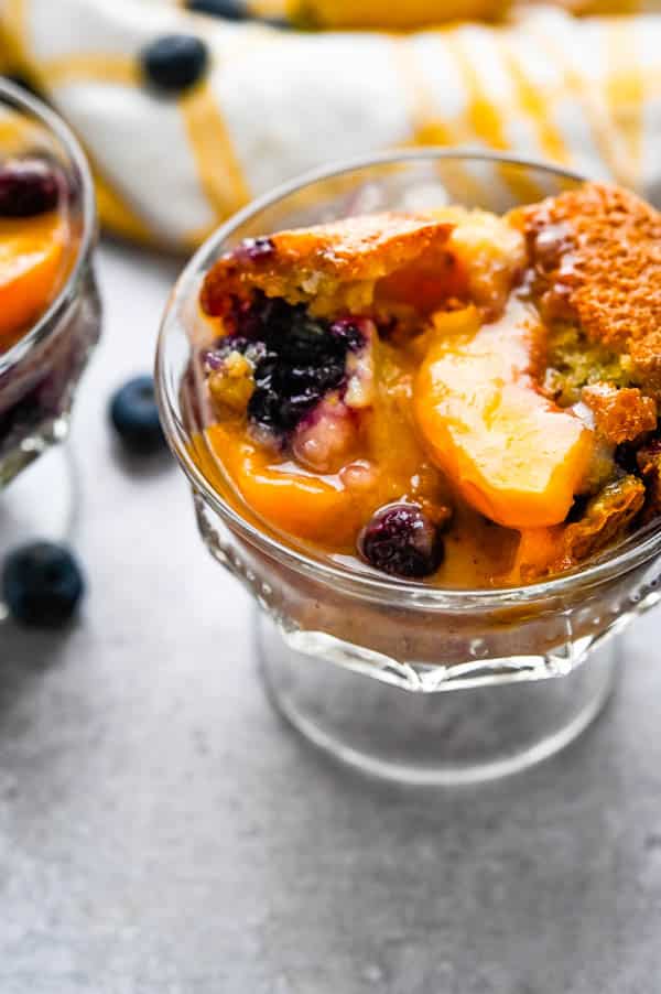 a dish of the fruit cobbler recipe with fresh peaches and blueberries. It's one of the best summer treats.