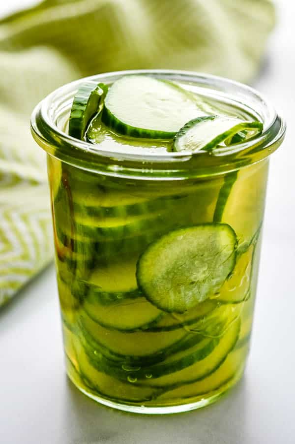 freshly made quick pickled cucumbers in a jar.