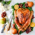 A brined roast turkey on a serving platter.