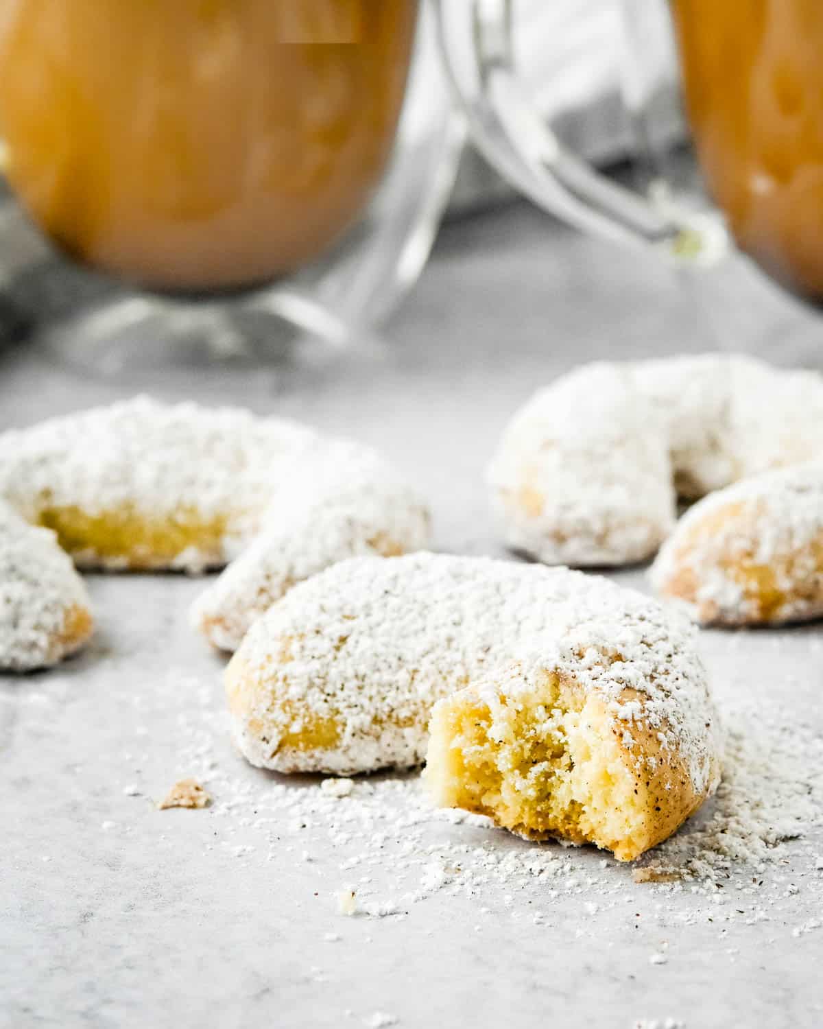Almond crescent cookies with cups of coffee for a snack.