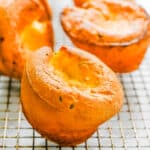 A wire rack filled with popovers.