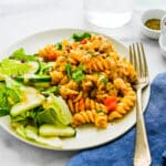 Turkey casserole served on a plate with a green salad.