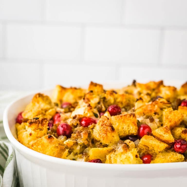 oven french toast with sausage, apples and cranberries in a pyrex dish.