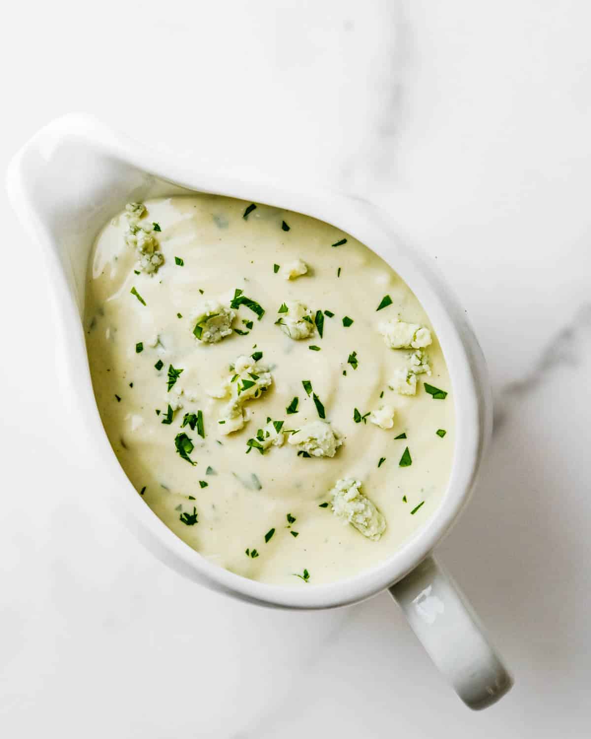 A pitcher of homemade blue cheese dressing.