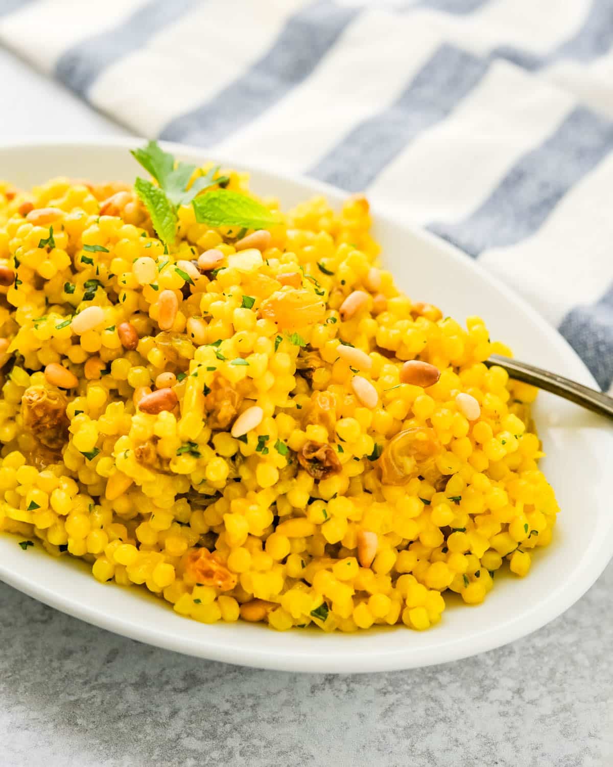Turmeric couscous with golden raisins and pine nuts.