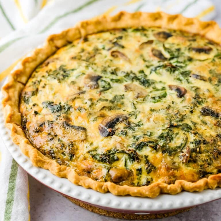 A kale and mushroom quiche in a baked crust.