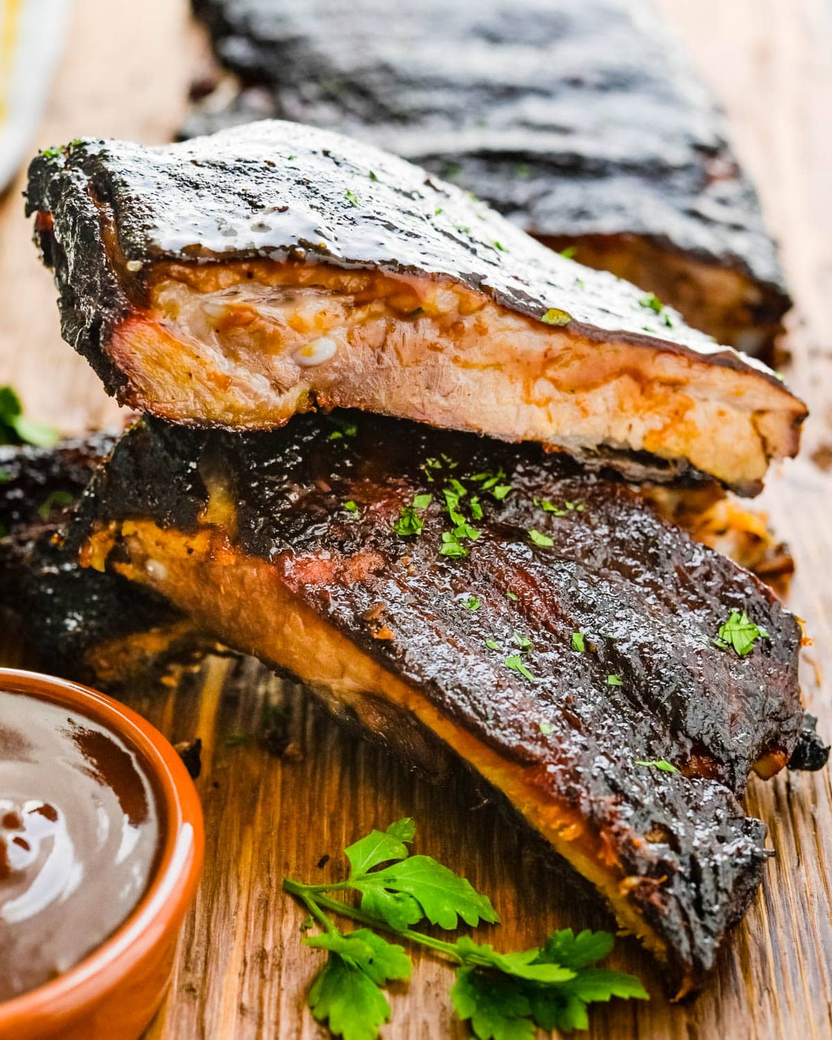A stack of double-cut Kansas City Ribs with barbecue sauce.