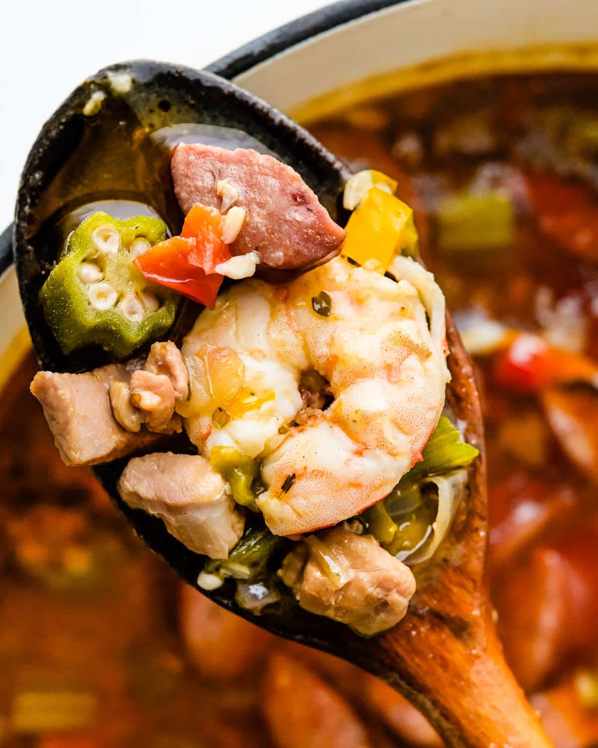 A pot of gumbo with chicken, sausage and seafood.