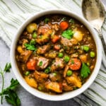 A bowl of Irish lamb stew with a spoon.