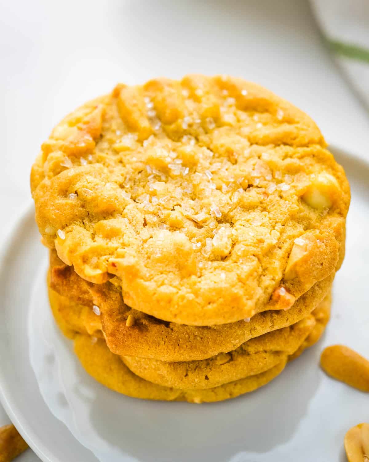 A stack of peanut butter white chocolate chip cookies on a plate. 