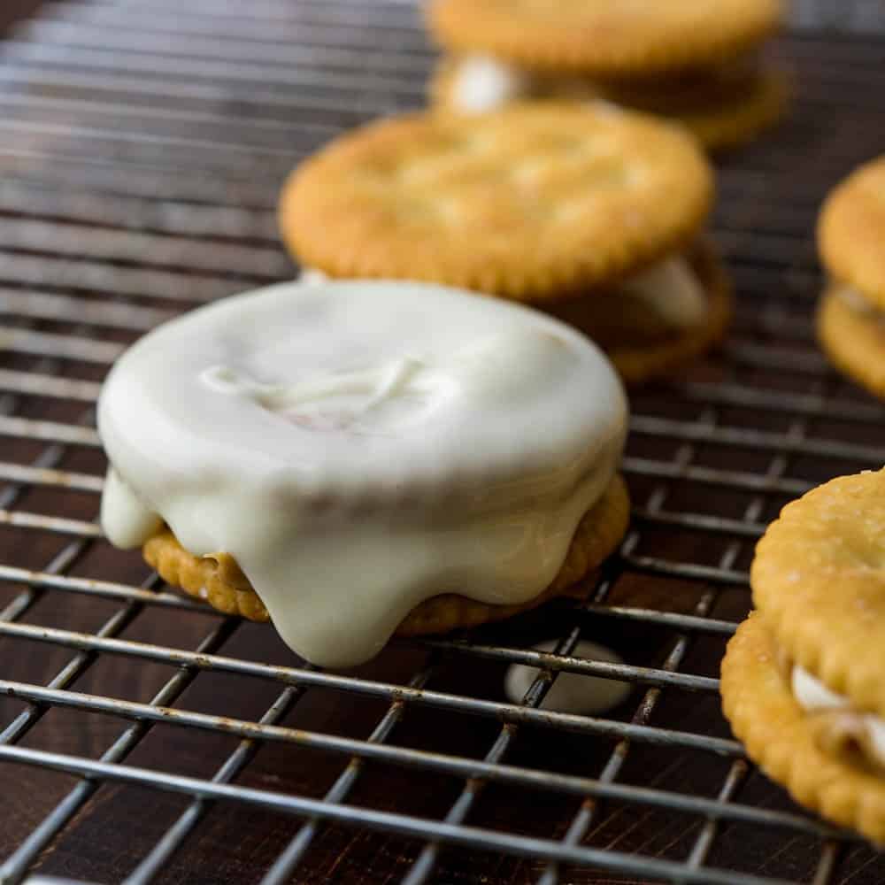 Letting the white chocolate on the cracker cookies dry on a wire rack.