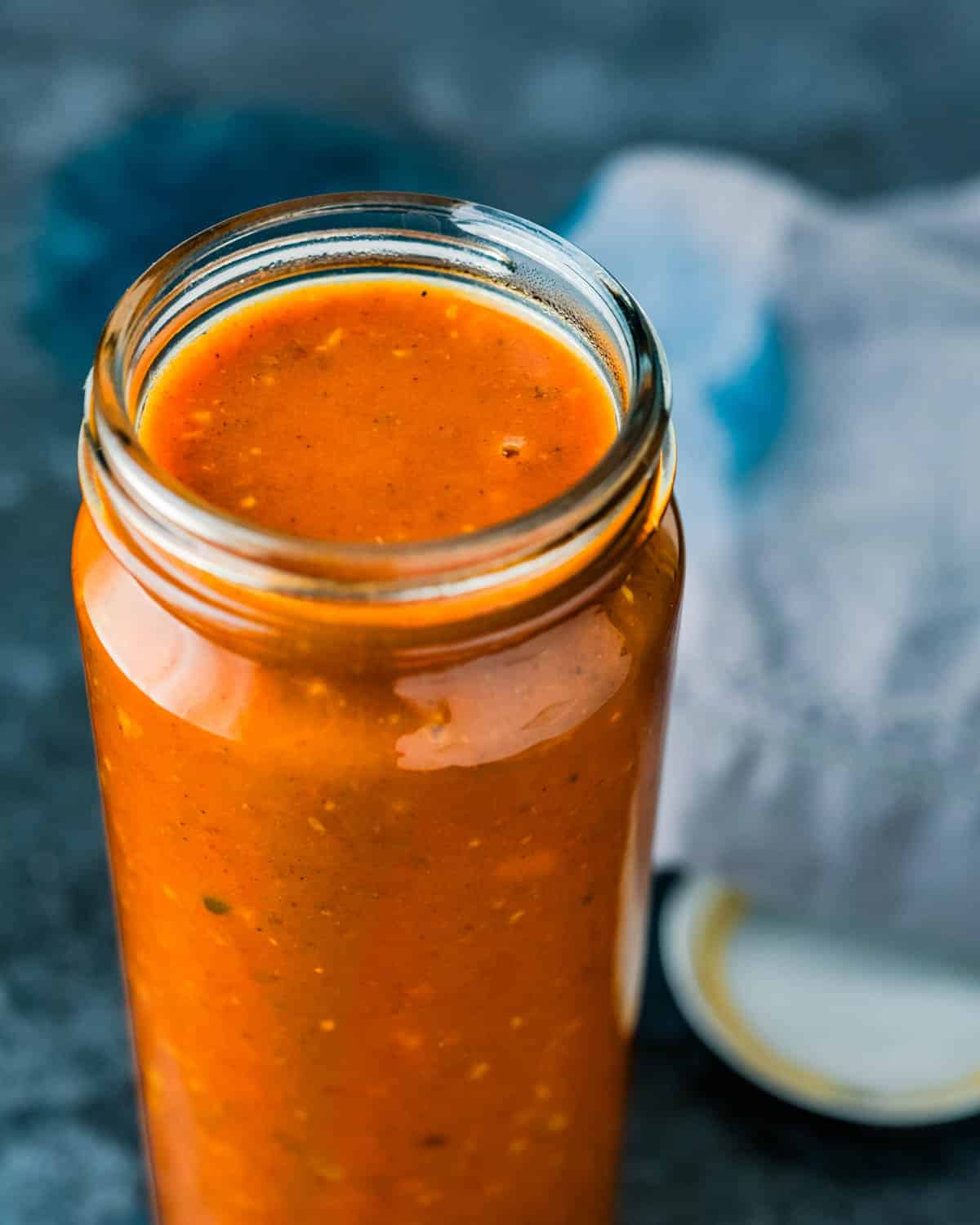 Storing the red enchilada sauce in a jar.