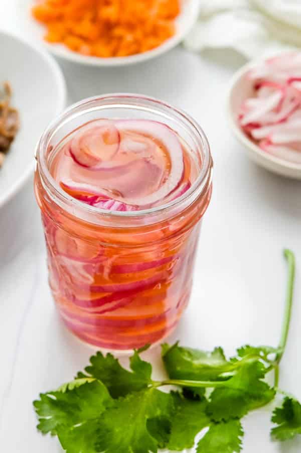 quick pickled red onions in a jar.