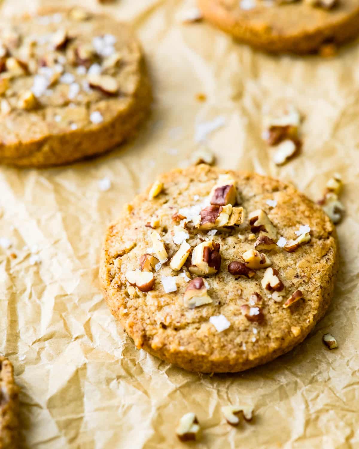 Butter pecan cookies on a sheet of parchment.