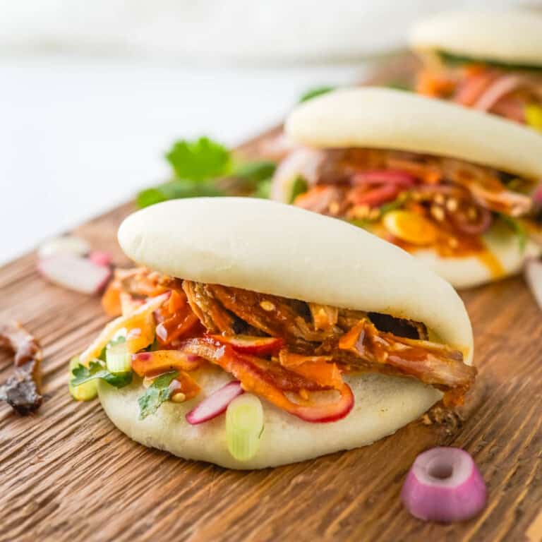 Asian BBQ Bao Buns on a wooden serving board.
