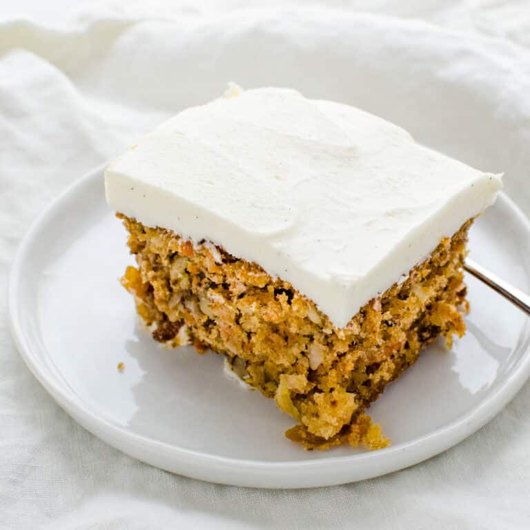 a slice of carrot cake with cream cheese frosting.