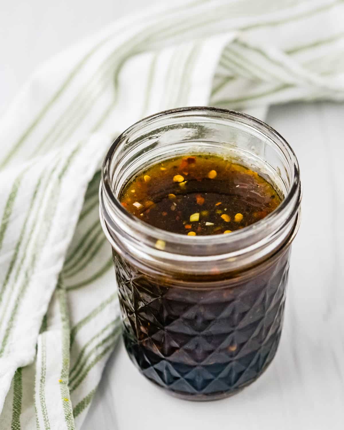 A jar of bourbon brown sugar marinade.