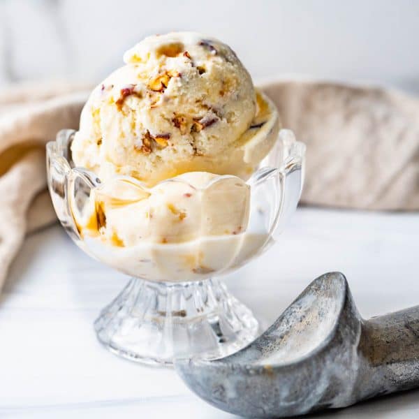 A scoop of bourbon pralines and cream ice cream with a scoop.