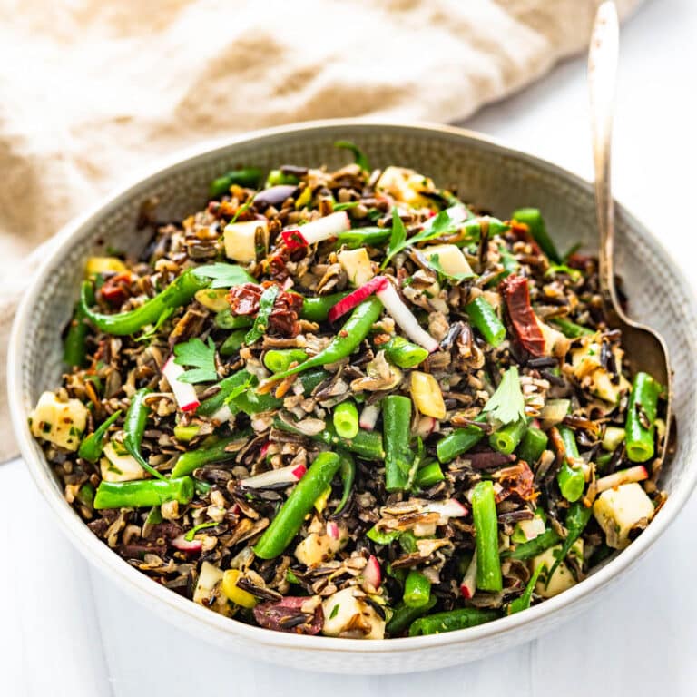 A bowl of wild rice salad with green beans.
