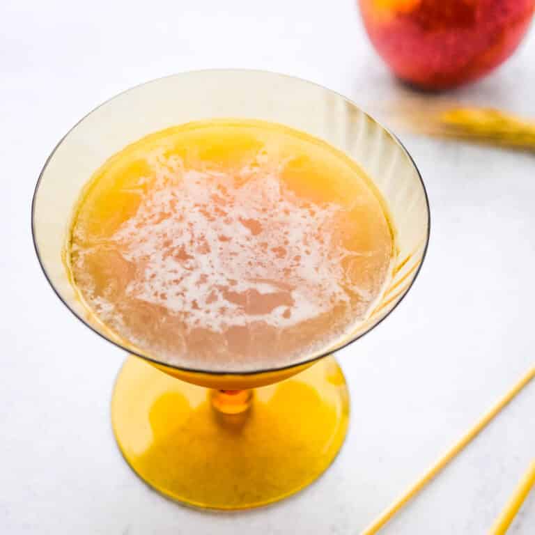 bourbon ginger and cider cocktail in a gold glass.