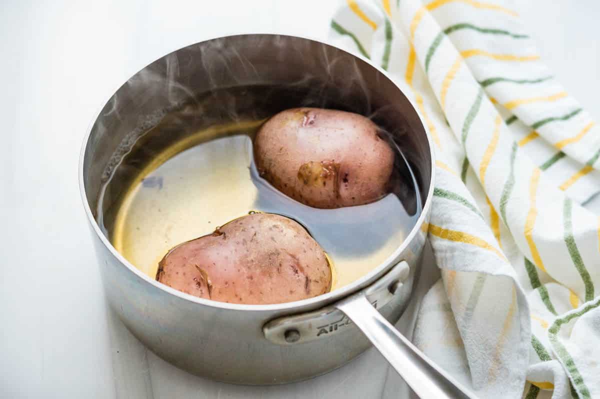 Boiling whple potatoes until tender.
