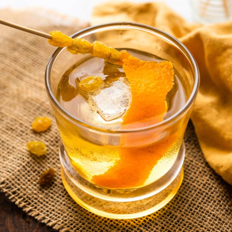 a rum raisin old fashioned with an orange peel garnish.