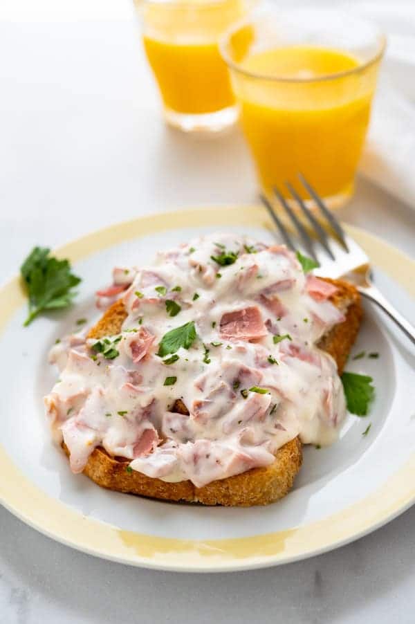 creamed chipped beef on toast with orange juice in the background.