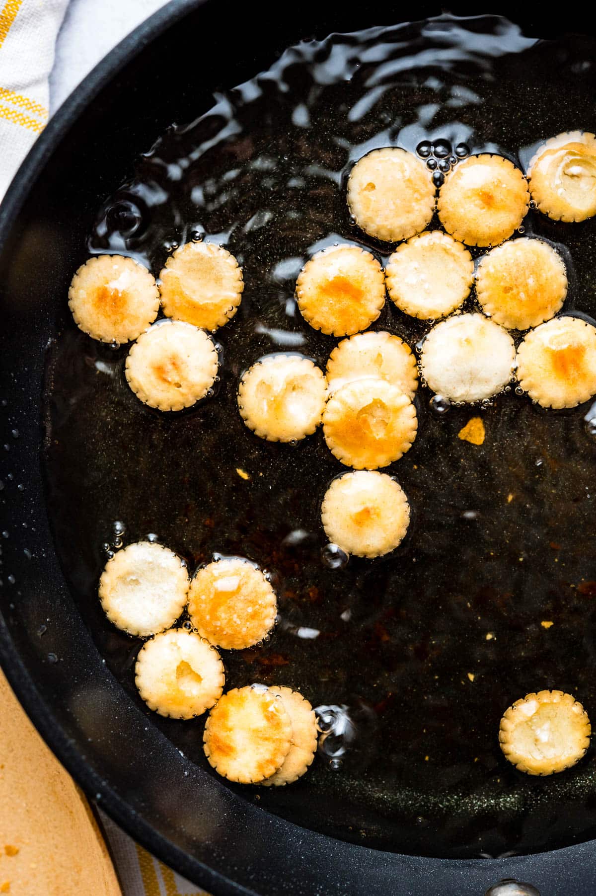 Frying the crackers in oil.
