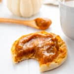 An English muffin topped with apple pumpkin butter.