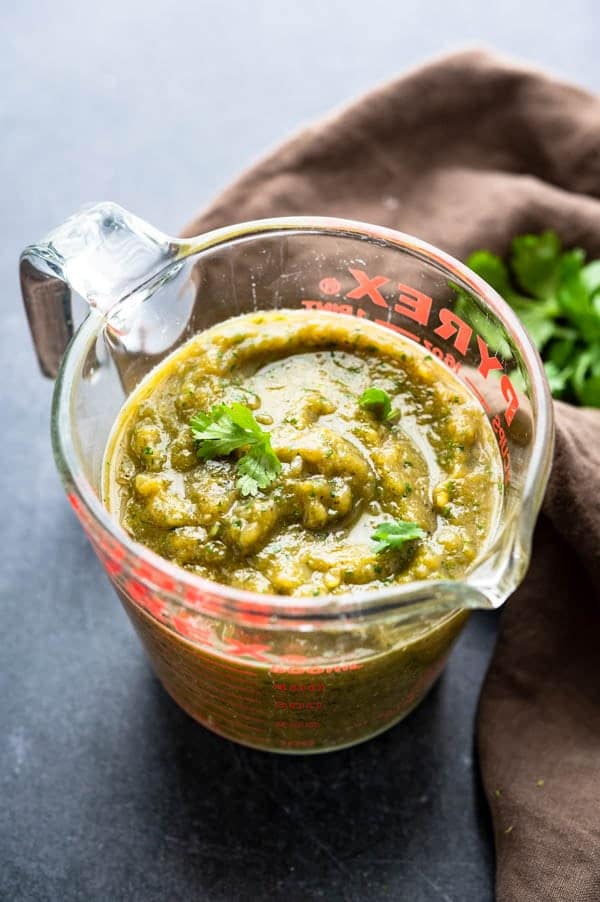 green chile sauce in a measuring cup.