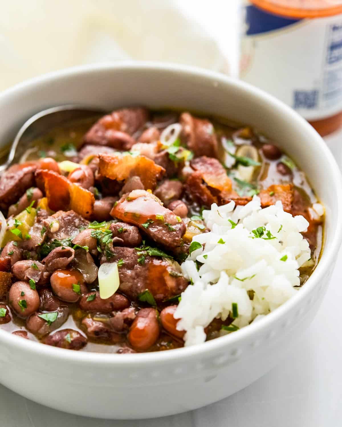 A bowl of sausage and red beans with rice.