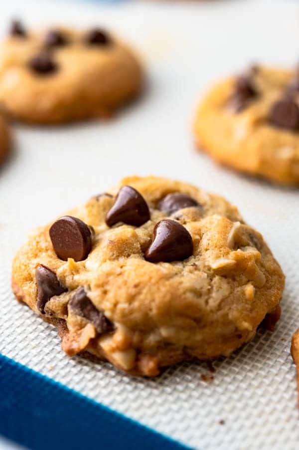 baked almond chocolate chip cookies on a baking sheet.