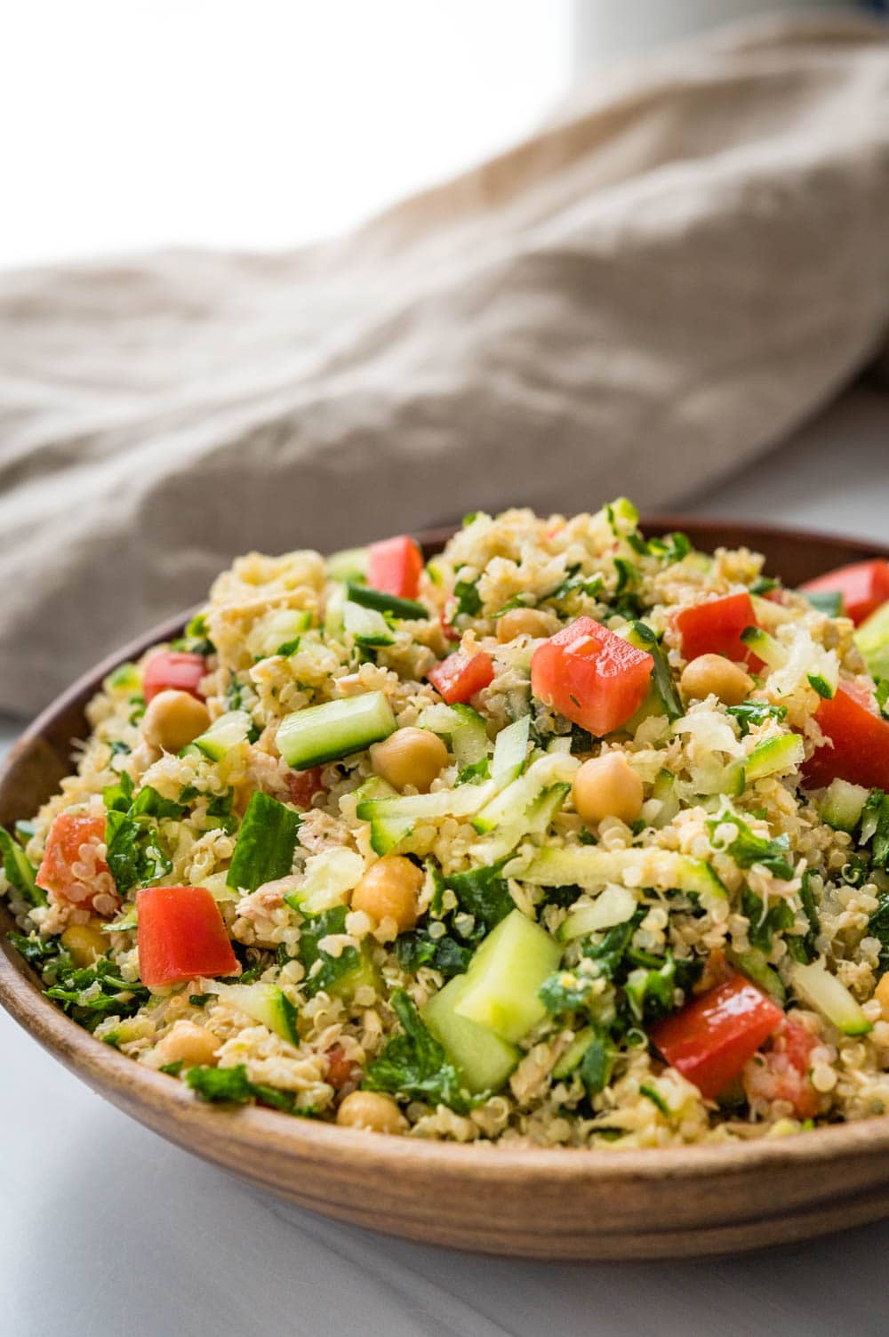 A large bowl of freshly made chickpea tuna salad with quinoa and kale.